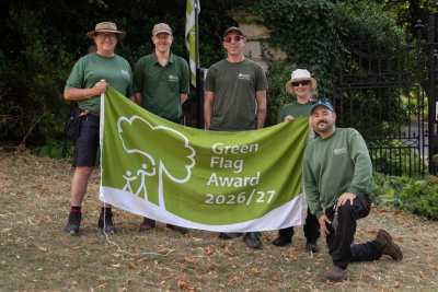 Gardens and Grounds team holding flag